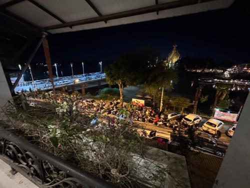 a view of a city at night with cars parked at Little Jasmine by the River in Phitsanulok
