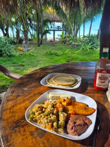 a table with two plates of food on it at The Chill Inn in Jiquilillo