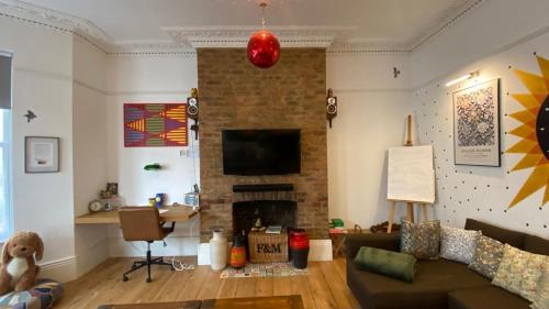 a living room with a couch and a fireplace at The Retreat Magnificent Sea Side Apartment in Hastings