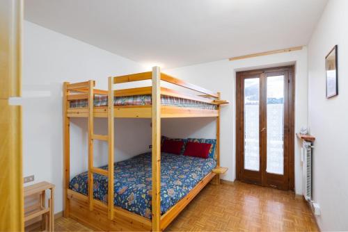 a bedroom with two bunk beds in a room at Bormio's Balcony - At the Spa in Premadio