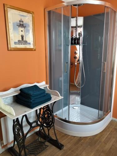 a shower with a glass enclosure in a bathroom at Monsieur Morgan's in Féniers