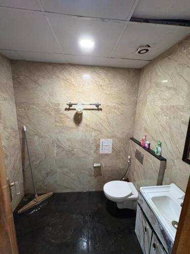 a bathroom with a toilet and a sink at The dream studio in Noida
