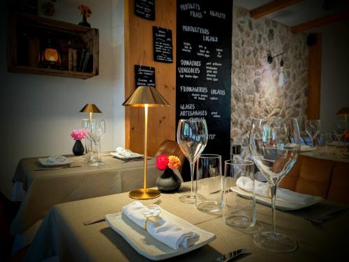 a table with wine glasses and napkins on it at Auberge Saint Antoine in Pelvoux
