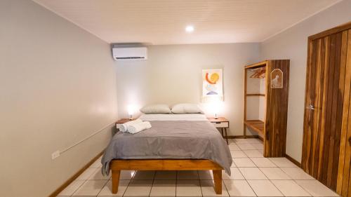 a bedroom with a bed with two pillows on it at GALA Santa Teresa Studios - Walk to Beach & Surf in Santa Teresa Beach
