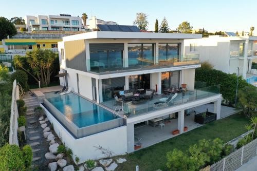 an aerial view of a house with a swimming pool at Modern Villa with Sea & River View Pool and Gym. in Lisbon