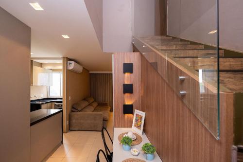 a staircase in a house with a living room at Luxurious 2-Bedroom Duplex with Gourmet Balcony in Goiânia