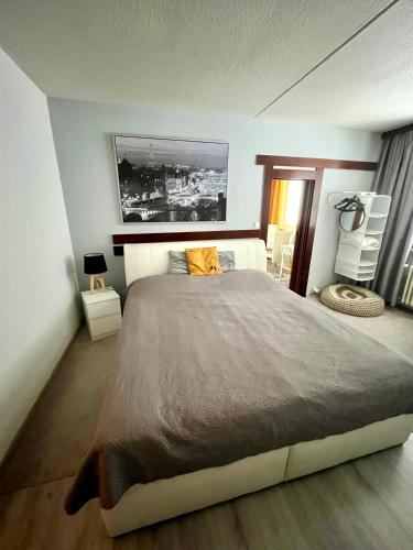 a bedroom with a large bed with an orange pillow at Apartmán BlueA in Jihlava