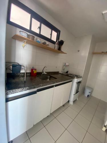 a small kitchen with a sink and a window at APARTAMENTO EM NATAL III in Natal