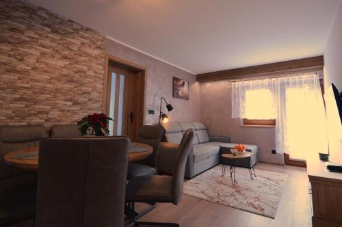 a living room with a couch and a table at Apartament Pod Jasieniem Jurgów in Jurgów