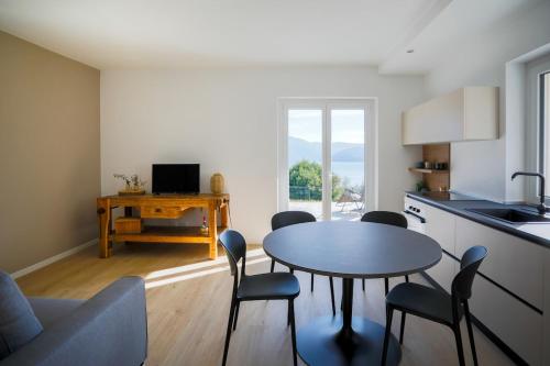 a kitchen with a table and chairs in a room at Dal Ross 2 in Riva di Solto