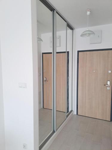 a room with sliding glass doors in a building at Apartament Cykady pod Warszawą in Zielonka