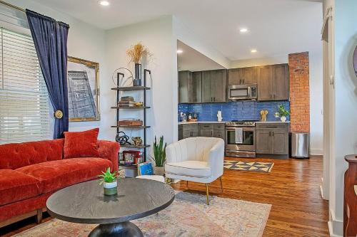 a living room with a red couch and a table at Top Walk score! Prime Westport Midtown Location! in Kansas City