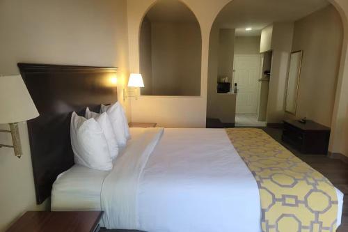 a bedroom with a large bed in a hotel room at Baymont by Wyndham Houston Brookhollow in Houston