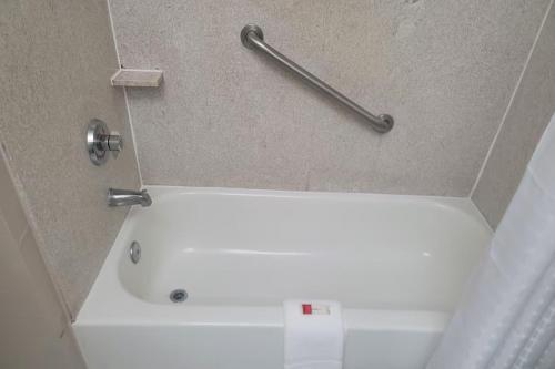 a bathroom with a bath tub with a towel bar at Baymont by Wyndham Houston Brookhollow in Houston