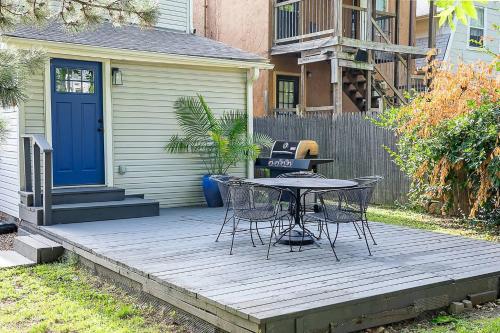 a wooden deck with a table and chairs on it at Top Walk score! Prime Westport Midtown Location! in Kansas City
