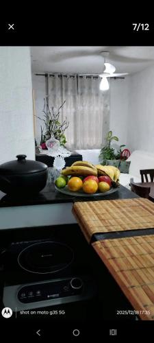 a plate of fruit on a counter in a kitchen at Eva in Vila Velha