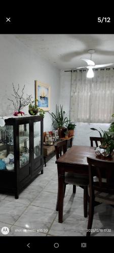 a living room with a table and chairs and a dining room at Eva in Vila Velha