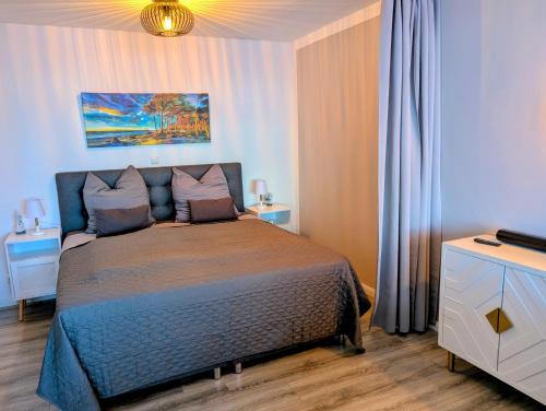 a bedroom with a bed and two night stands at Panorama-Meerblick am Scharbeutzer Strand in Scharbeutz