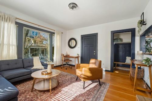 a living room with a couch and a table at Stay Portland - Perfectly Restored Craftsman - Eateries & Coffee in Portland