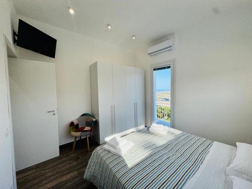 a bedroom with a bed with a large window at Al Grande Pino - Private pool, Jacuzzi and amazing Sunset in Campofelice di Roccella
