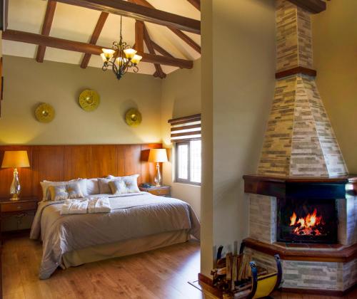 una camera da letto con un letto e un camino di Hosteria Duran a Cuenca