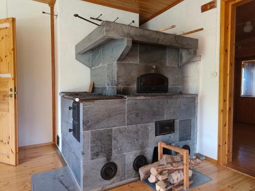 a stone oven in a room with a wall at Northern Cabin in Havukkavaara