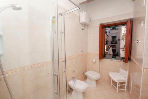 a bathroom with a shower and a toilet and a sink at Amalfi mia - city center in Amalfi