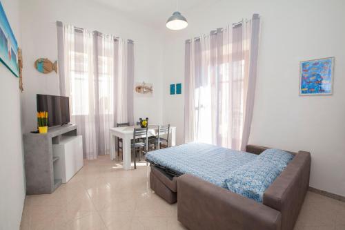 a bedroom with a bed and a desk and a television at Amalfi mia - city center in Amalfi