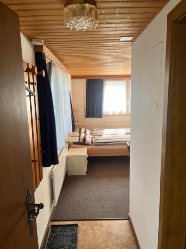 a small room with two beds and a window at Ferienwohnung Inauen in Appenzell