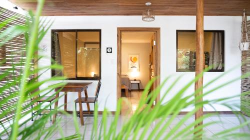 a room with a table and chairs in a house at GALA Santa Teresa Studios - Walk to Beach & Surf in Santa Teresa Beach