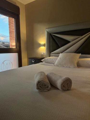 a bedroom with a bed with towels on it at Martín Taberna in Villavieja del Lozoya