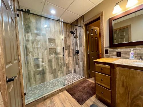 a bathroom with a shower with a glass shower stall at Lake Oconee Waterfront Apartment in Greensboro