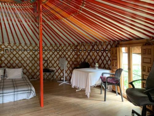 a room with a table and a bed in a yurt at Yurta cerca de Madrid in Madrid