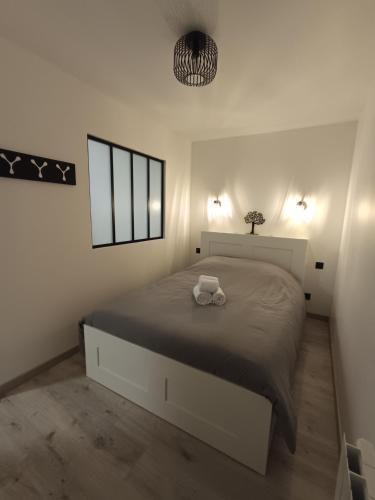 a bedroom with a large bed in a white room at Chez Mat's & Lou in Rocheville