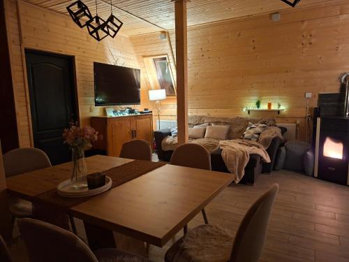 a living room with a couch and a table at Escape Remeti - Aframe by the River in Remeţi