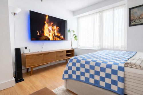 a bedroom with a bed and a fire in the wall at Modern Studio with Private Bathroom and Kitchen in New York