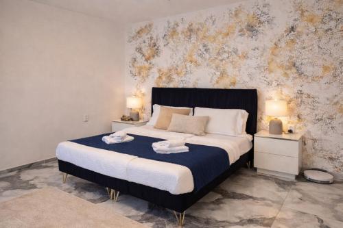 a bedroom with a large bed with two night stands at Apartman VEMY in Trnava