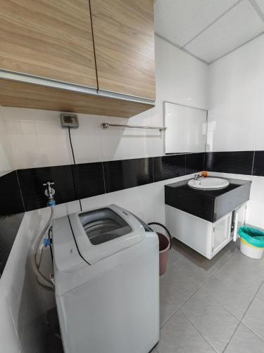 a kitchen with a washing machine and a sink at Seaview Mansion One Georgetown in George Town