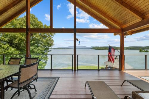 a screened in porch with a view of the water at Cozy Cabin Style Lake House w Theatre Room & Dock in Sevierville