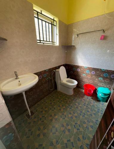 a bathroom with a sink and a toilet at Kudle Heaven in Gokarna