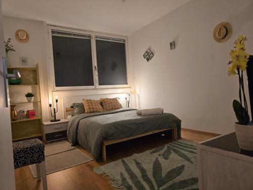 a bedroom with a bed and a large window at welcome geneva in Geneva