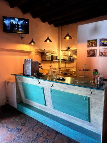 a kitchen with a counter with a blue door at Hotel Ruinas Del Real in Real de Catorce
