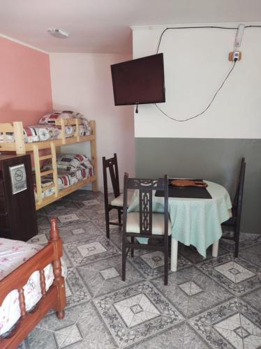 a room with a table and chairs and a tv at Las Tres Reinas A in Colorado River