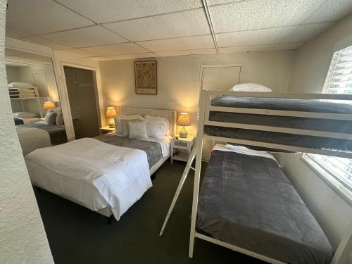 a bedroom with two bunk beds and a window at Grand Central Motel in Ely