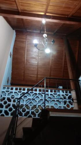 a staircase in a house with a chandelier at Quinta Atalaya in General Rodríguez