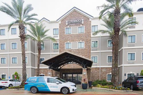 a hotel with a car parked in front of it at Staybridge Suites Lafayette-Airport by IHG in Lafayette