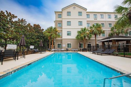 a swimming pool in front of a building at Staybridge Suites Lafayette-Airport by IHG in Lafayette