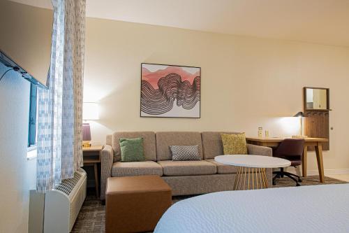 a living room with a couch and a table at Staybridge Suites Lafayette-Airport by IHG in Lafayette