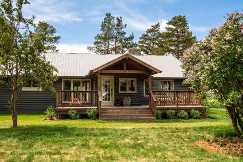 a house with a porch and a deck at Copper Rose Ranch in Livingston