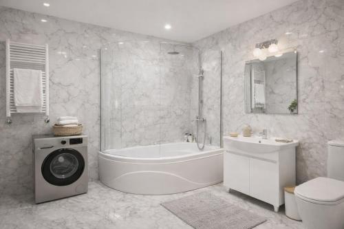 a bathroom with a tub and a toilet and a sink at Gagarin Luxury Apartment in Samarkand